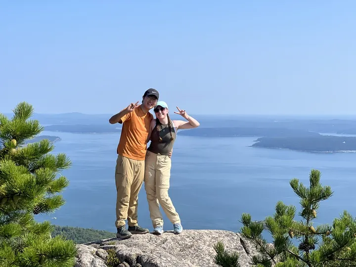 The two of us on a granite summit above the bay, throwing peace signs